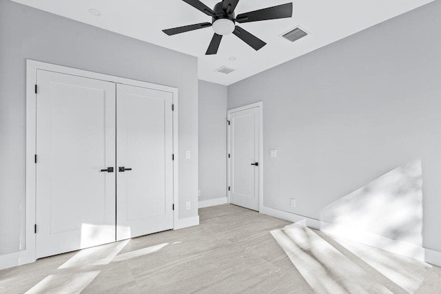 unfurnished bedroom with a closet and ceiling fan