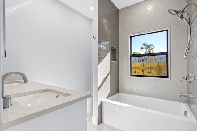 bathroom with vanity, tiled shower / bath, and tile patterned flooring