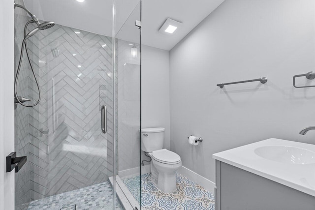 bathroom featuring vanity, tile patterned floors, toilet, and an enclosed shower