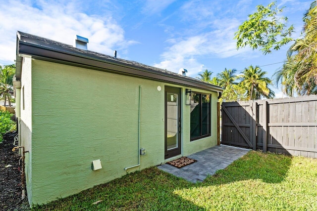 rear view of house featuring a lawn