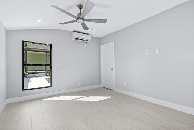 empty room featuring a wall mounted air conditioner, lofted ceiling, light wood-type flooring, and ceiling fan