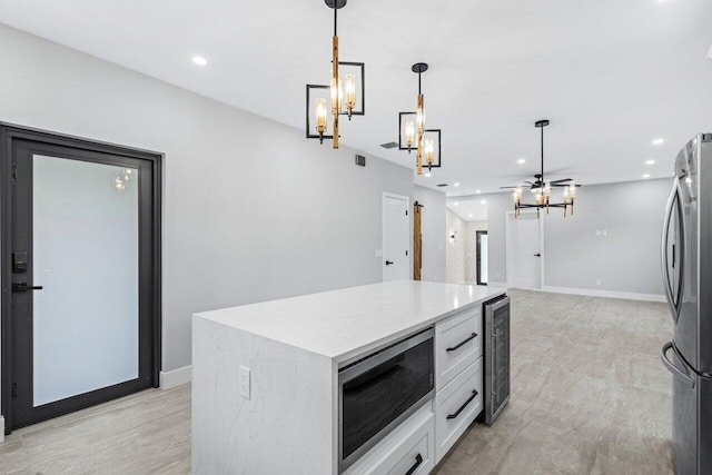 kitchen with wine cooler, white cabinetry, stainless steel appliances, pendant lighting, and a center island