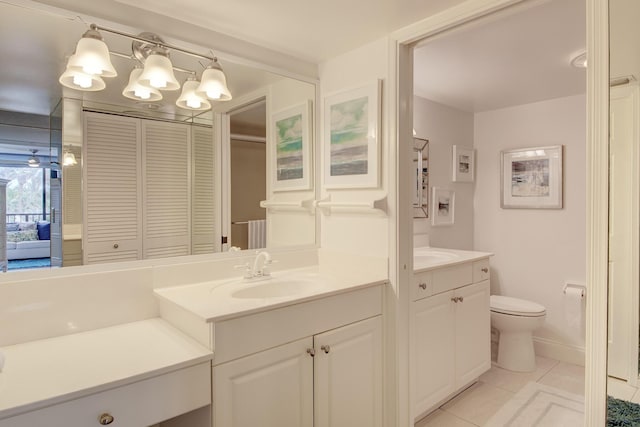 bathroom featuring tile patterned floors, vanity, and toilet