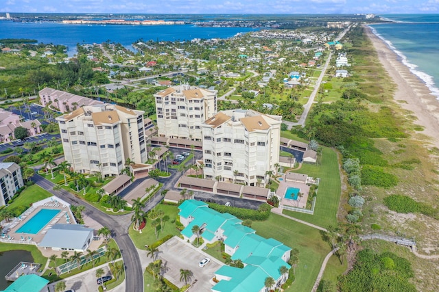 bird's eye view featuring a water view and a beach view