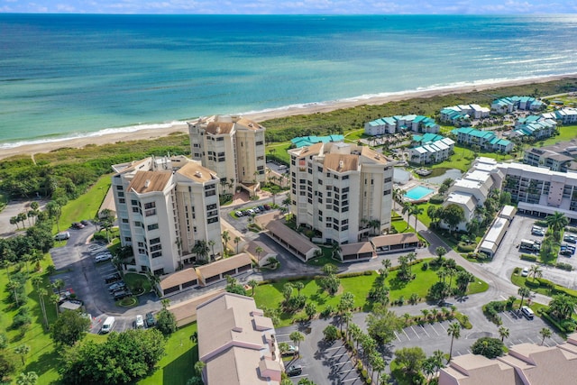 drone / aerial view featuring a view of the beach and a water view