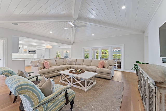 living room featuring vaulted ceiling with beams, ceiling fan, light wood-type flooring, and wood ceiling