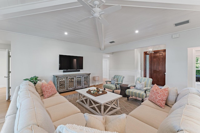 living room with hardwood / wood-style floors, lofted ceiling with beams, and ceiling fan