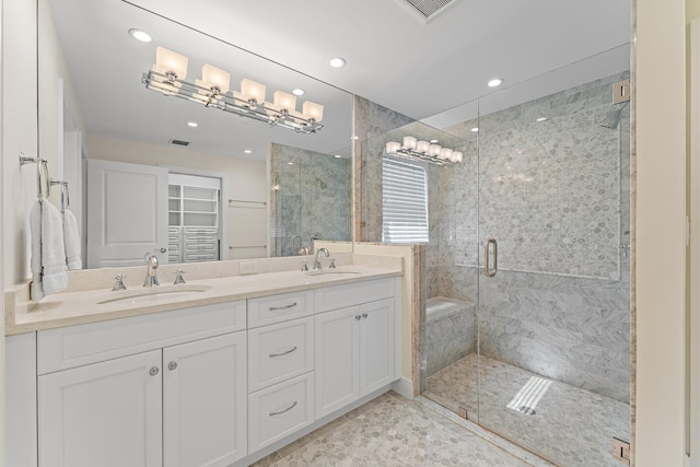 bathroom featuring vanity and an enclosed shower