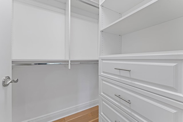 walk in closet featuring light hardwood / wood-style flooring