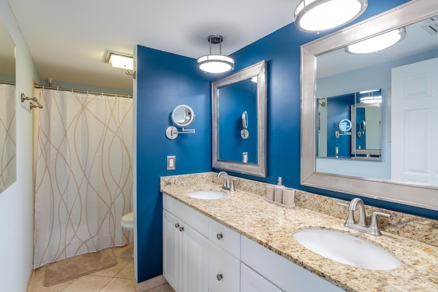 bathroom featuring walk in shower, vanity, toilet, and tile patterned floors