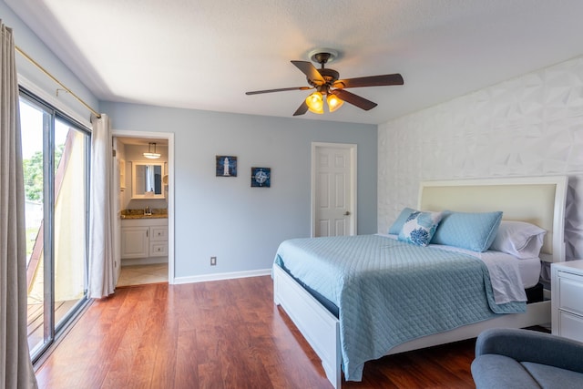 bedroom with access to outside, ensuite bath, sink, hardwood / wood-style floors, and ceiling fan