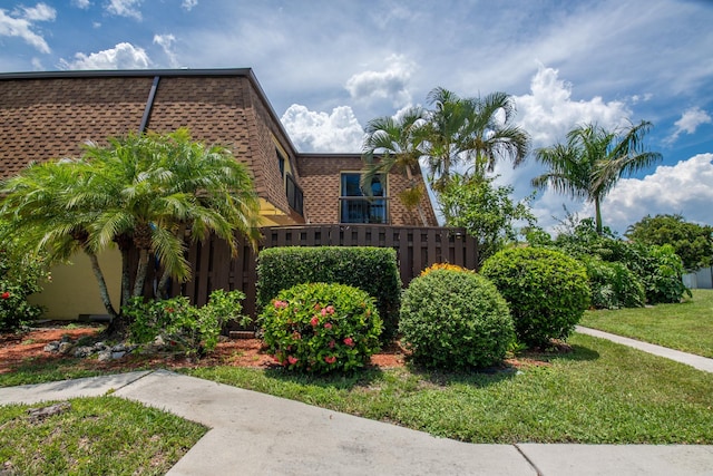 view of side of home with a yard