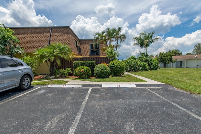 view of vehicle parking featuring a lawn