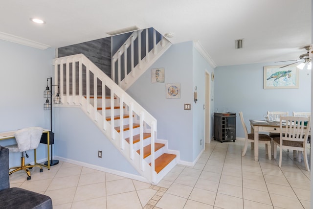 stairway with crown molding, tile patterned flooring, and ceiling fan