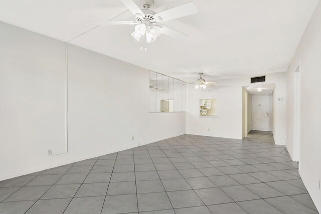 kitchen featuring ceiling fan, light tile patterned floors, and white appliances