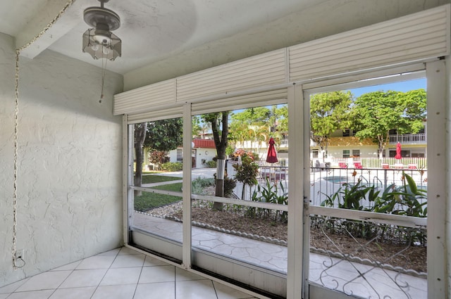 doorway to outside with light tile patterned flooring