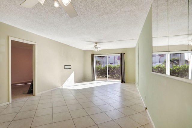 spare room featuring ceiling fan, a textured ceiling, and light tile patterned floors