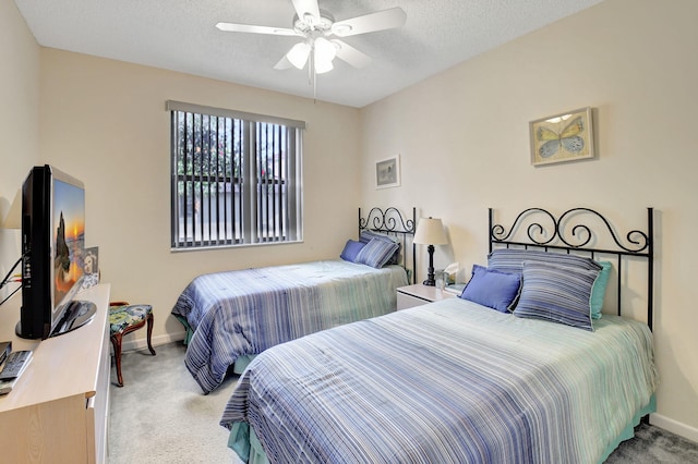 carpeted bedroom with a textured ceiling and ceiling fan