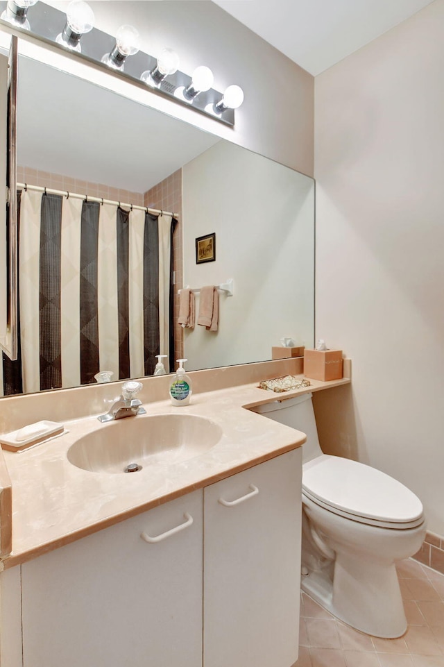 bathroom with tile patterned floors, vanity, and toilet