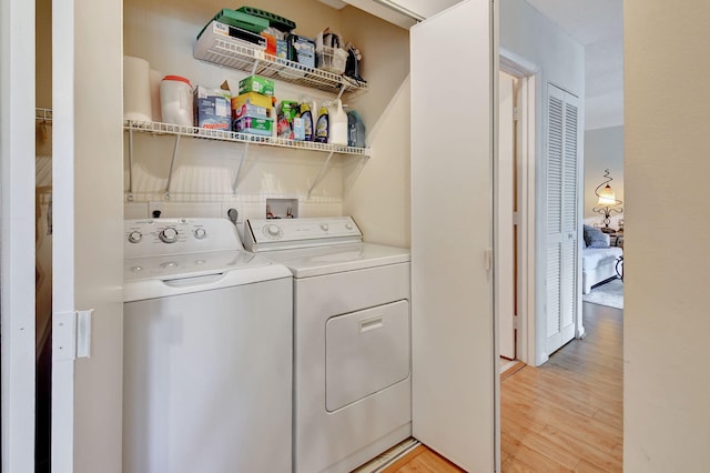 washroom featuring washer and dryer and light wood-type flooring