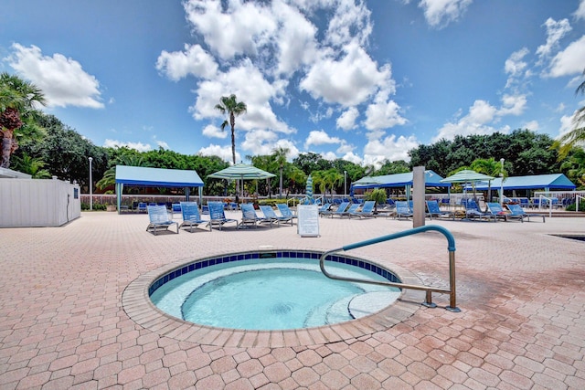 view of swimming pool with a community hot tub