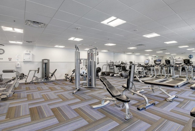 workout area featuring carpet floors and a drop ceiling