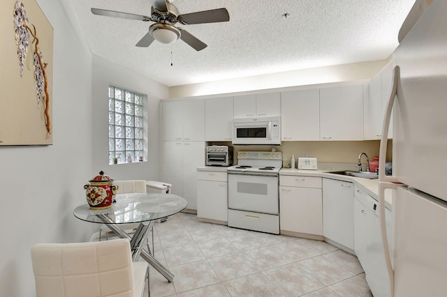 kitchen with a textured ceiling, white appliances, ceiling fan, sink, and white cabinets