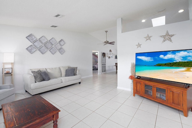 living room featuring vaulted ceiling, light tile patterned floors, and ceiling fan