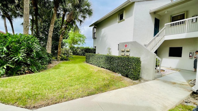 view of yard featuring a balcony and a patio