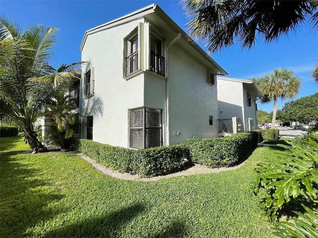 view of property exterior featuring a lawn