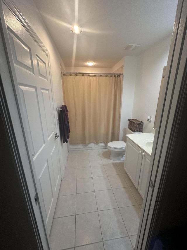 bathroom featuring tile patterned floors, vanity, and toilet