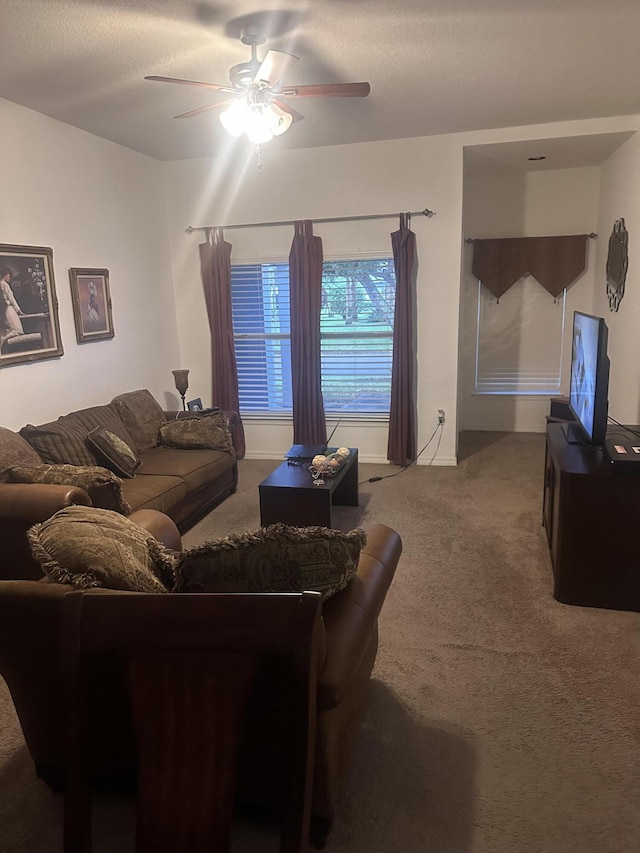 living room featuring carpet flooring, a textured ceiling, and ceiling fan