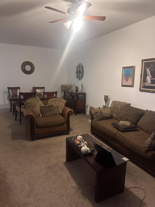 living room featuring ceiling fan and carpet