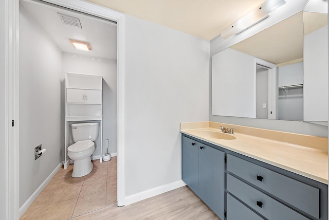 bathroom with vanity, toilet, and tile patterned floors