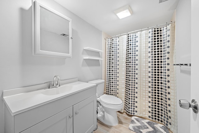 bathroom with toilet, hardwood / wood-style flooring, vanity, and a shower with curtain