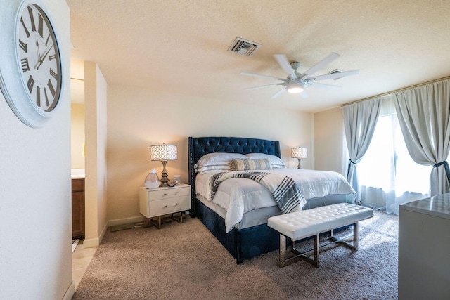 bedroom featuring a textured ceiling, carpet flooring, and ceiling fan