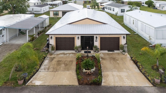 view of front of house with a carport, a front yard, and a garage