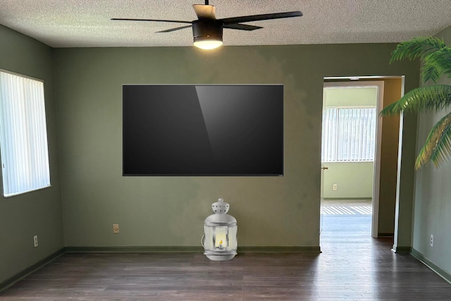 spare room with ceiling fan, a textured ceiling, and dark hardwood / wood-style flooring