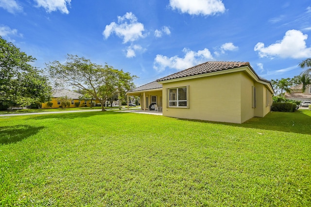 back of property featuring a lawn