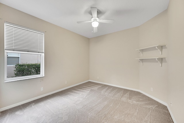 carpeted empty room featuring ceiling fan