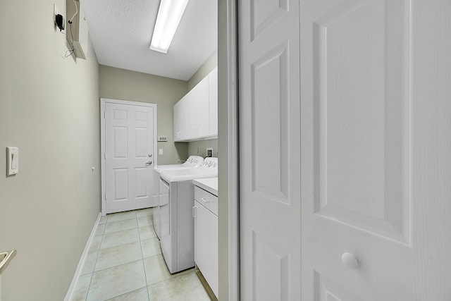 laundry area with cabinets, washer hookup, and light tile patterned floors