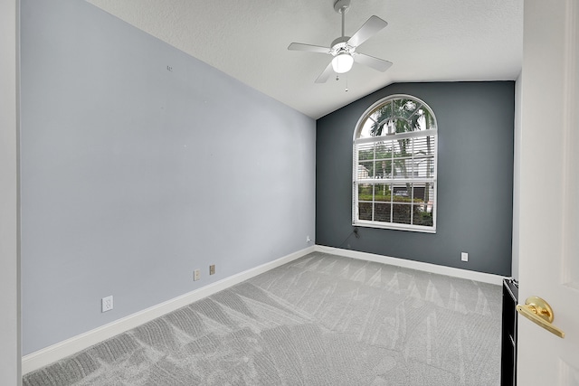 unfurnished room with carpet floors, ceiling fan, a textured ceiling, and vaulted ceiling