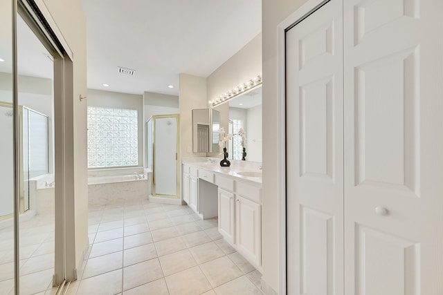 bathroom with vanity, a shower with shower door, and tile patterned flooring