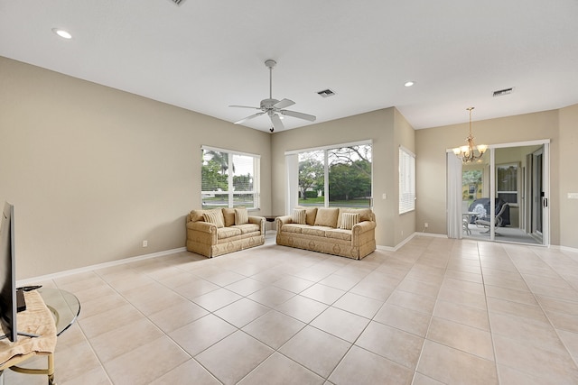 unfurnished living room with ceiling fan with notable chandelier and light tile patterned floors