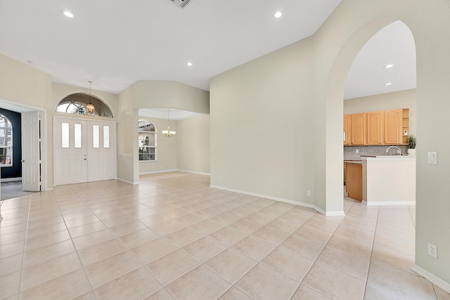 entryway featuring light tile patterned flooring and an inviting chandelier