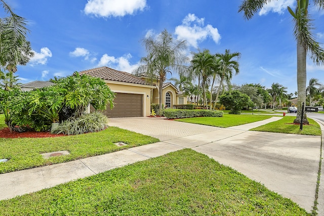 mediterranean / spanish-style home with a garage and a front lawn