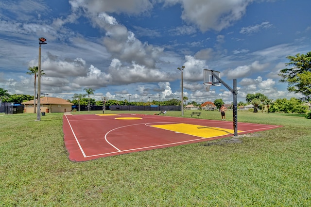 view of sport court with a yard