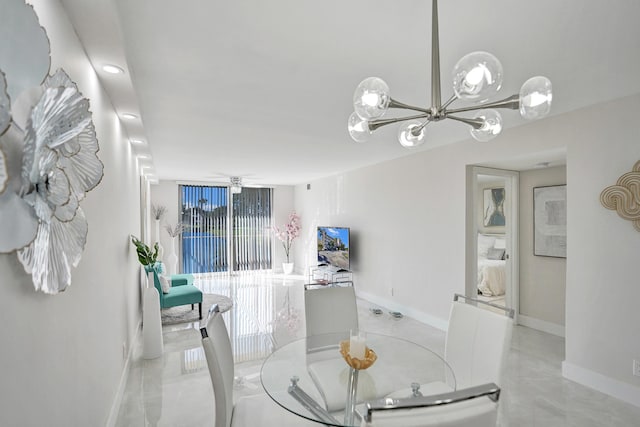 dining room with baseboards and a chandelier
