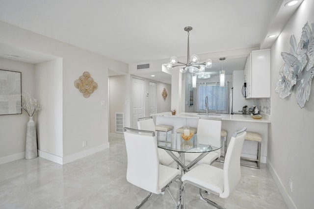 dining room featuring sink and a chandelier