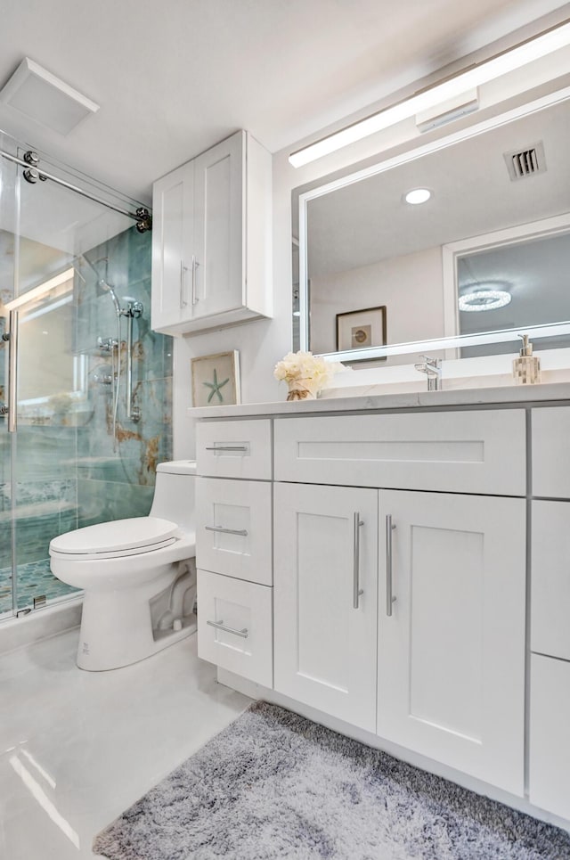 bathroom with vanity, toilet, and walk in shower